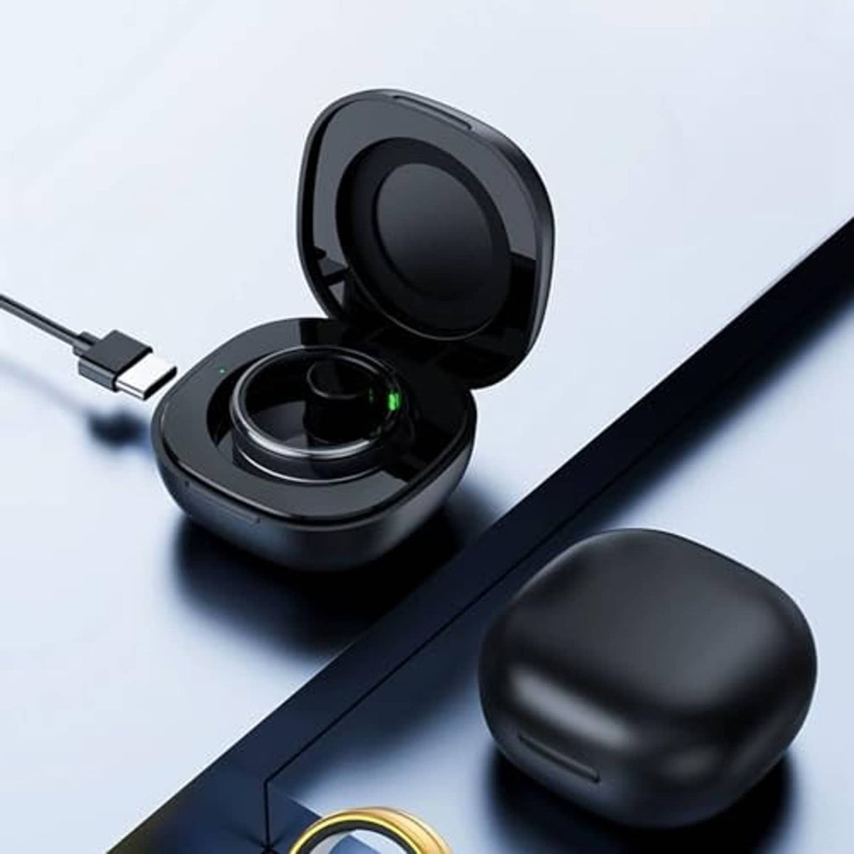 Black magnetic charging case open with USB cable connected to the charging base