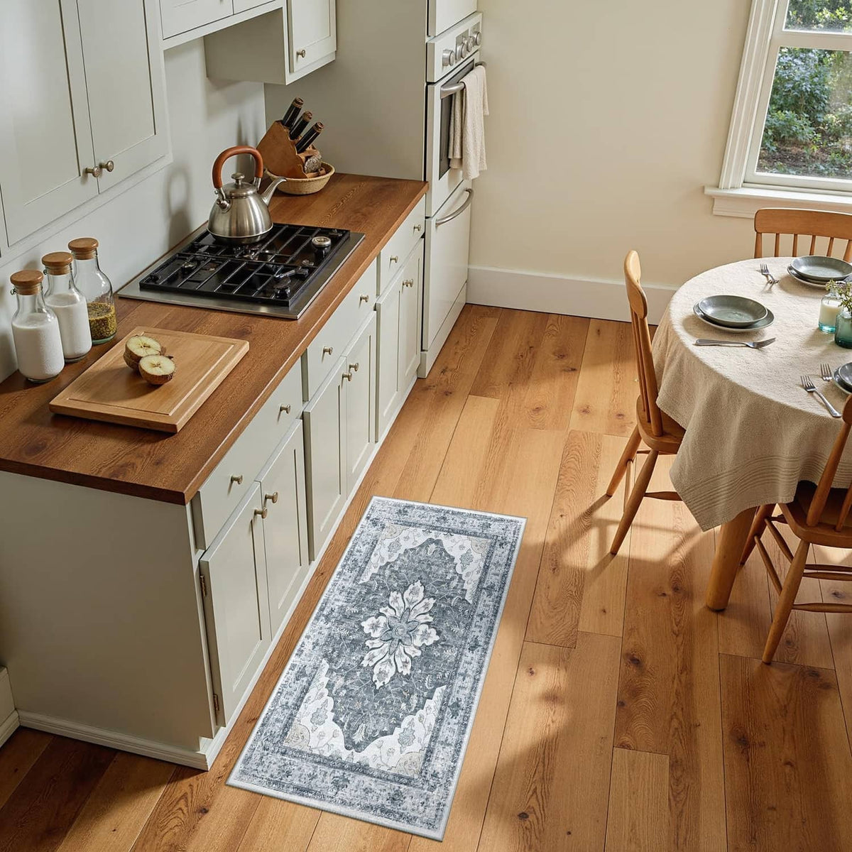 Small rectangular washable area rug with grey and white ornate floral border pattern