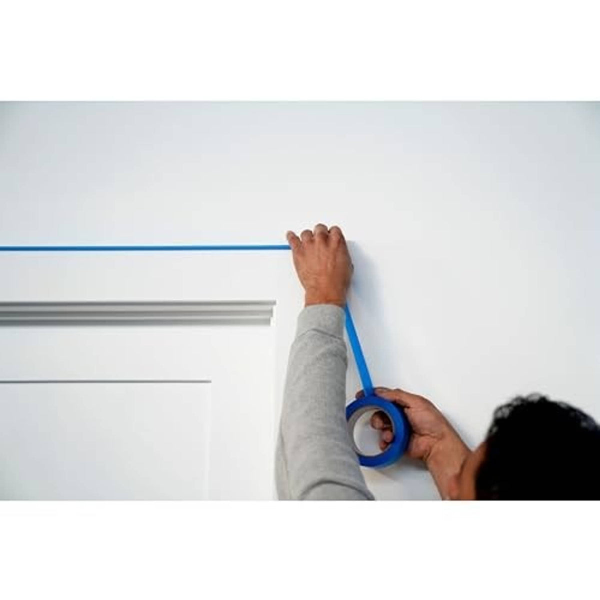 Blue painter's tape masking a trim edge for clean paint lines