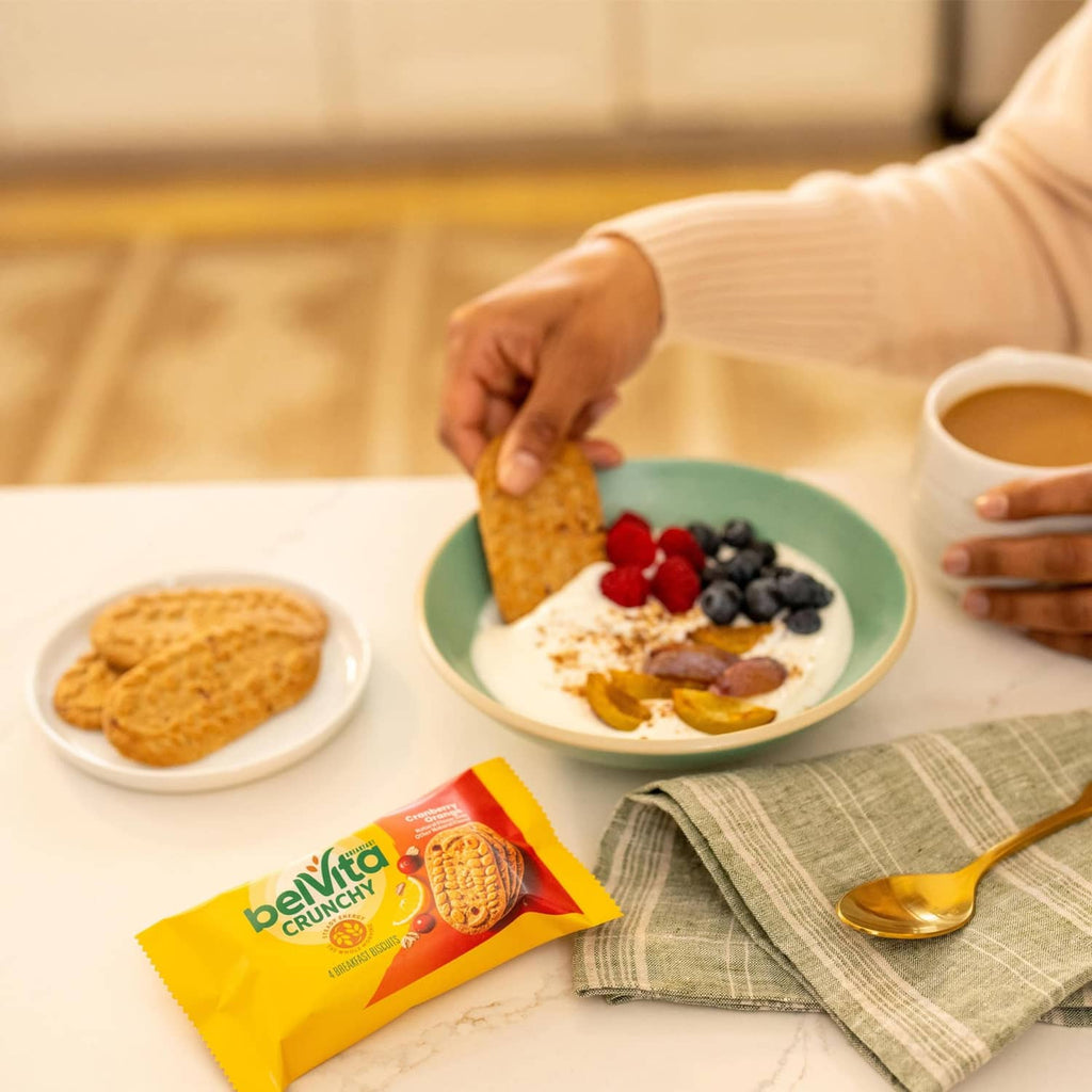 Belvita Crunchy cranberry-orange breakfast biscuits pack on breakfast table with food