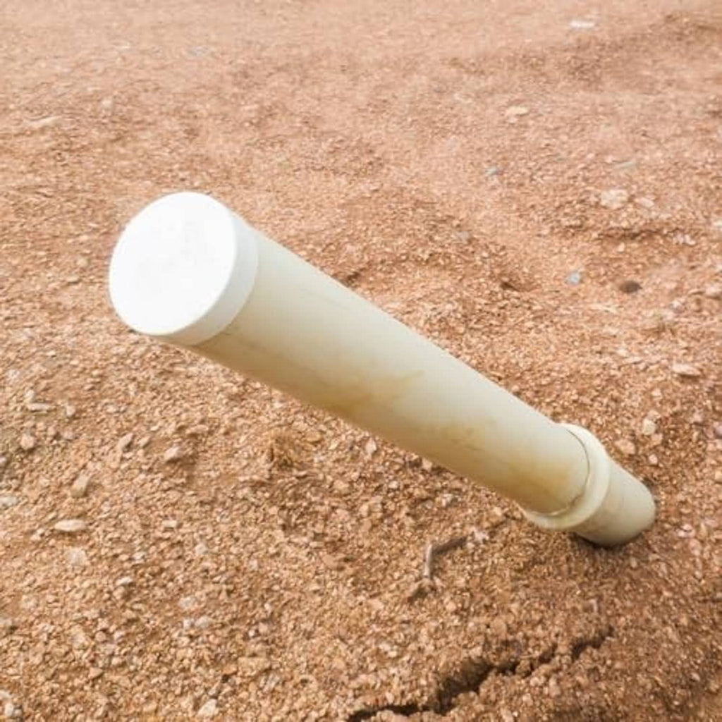 Light-colored UPVC pipe end cap plug fitting attached to a short white pipe section
