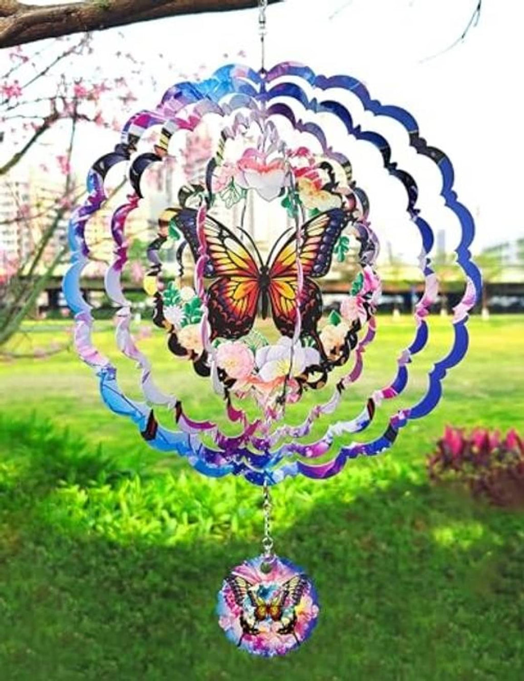 Front view butterfly wind spinner with purple-blue layered metal blades and round pendant