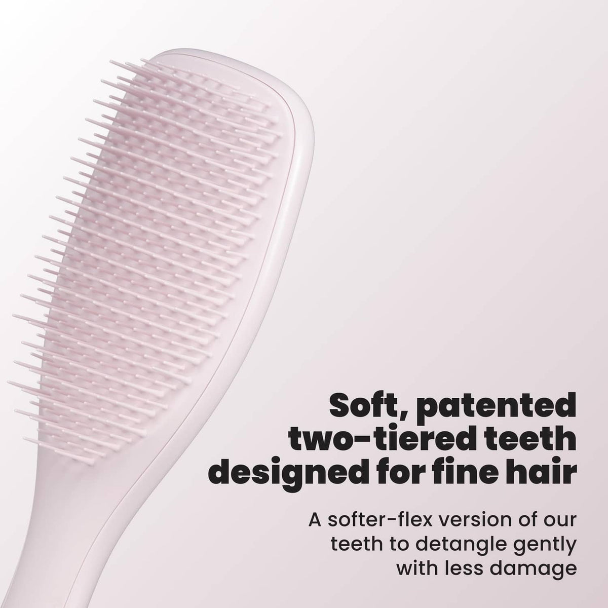 Pink Frost detangling hairbrush with two-tiered teeth, angled close-up