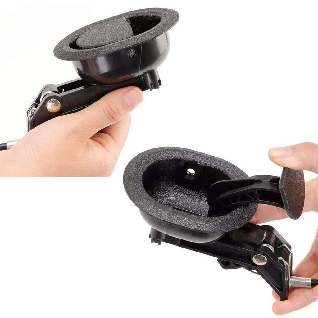 Black recliner release handle held by hand, showing circular grip and lever
