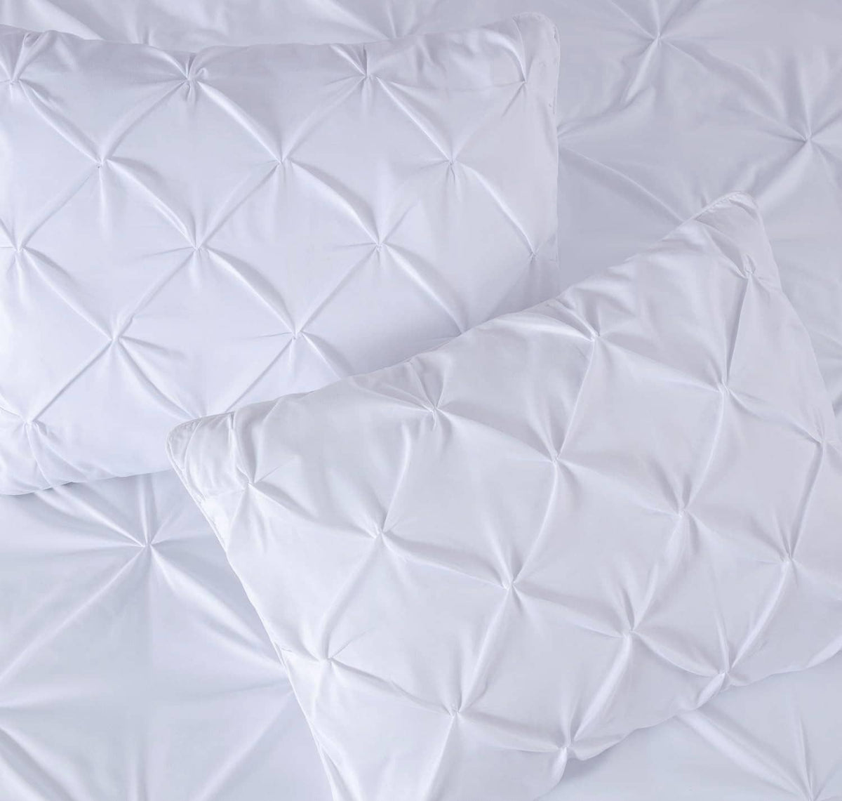 White pillow sham pair with quilted diamond pinch pleat texture