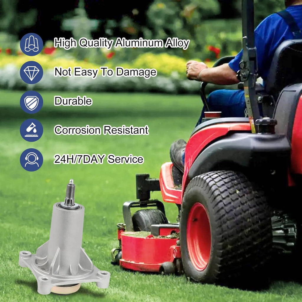 Silver mower spindle assembly on lawn equipment, showing mounting base and top cap