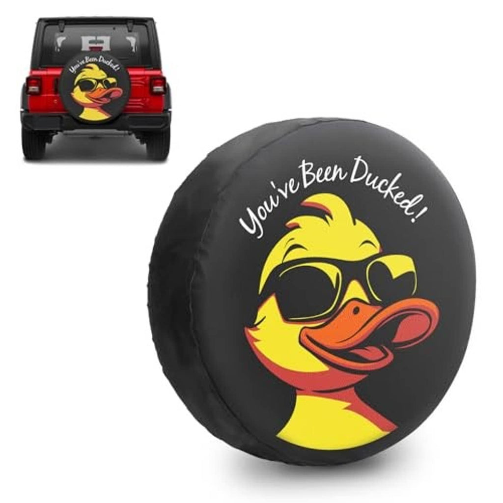 Black round spare tire cover featuring a smiling yellow duck face graphic