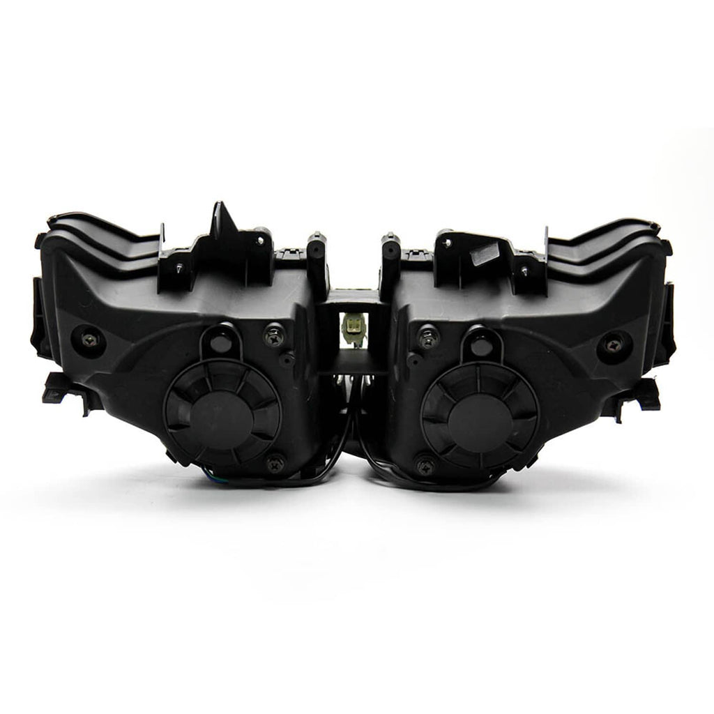 Pair of headlight assemblies with black rear housings and round mounting sections