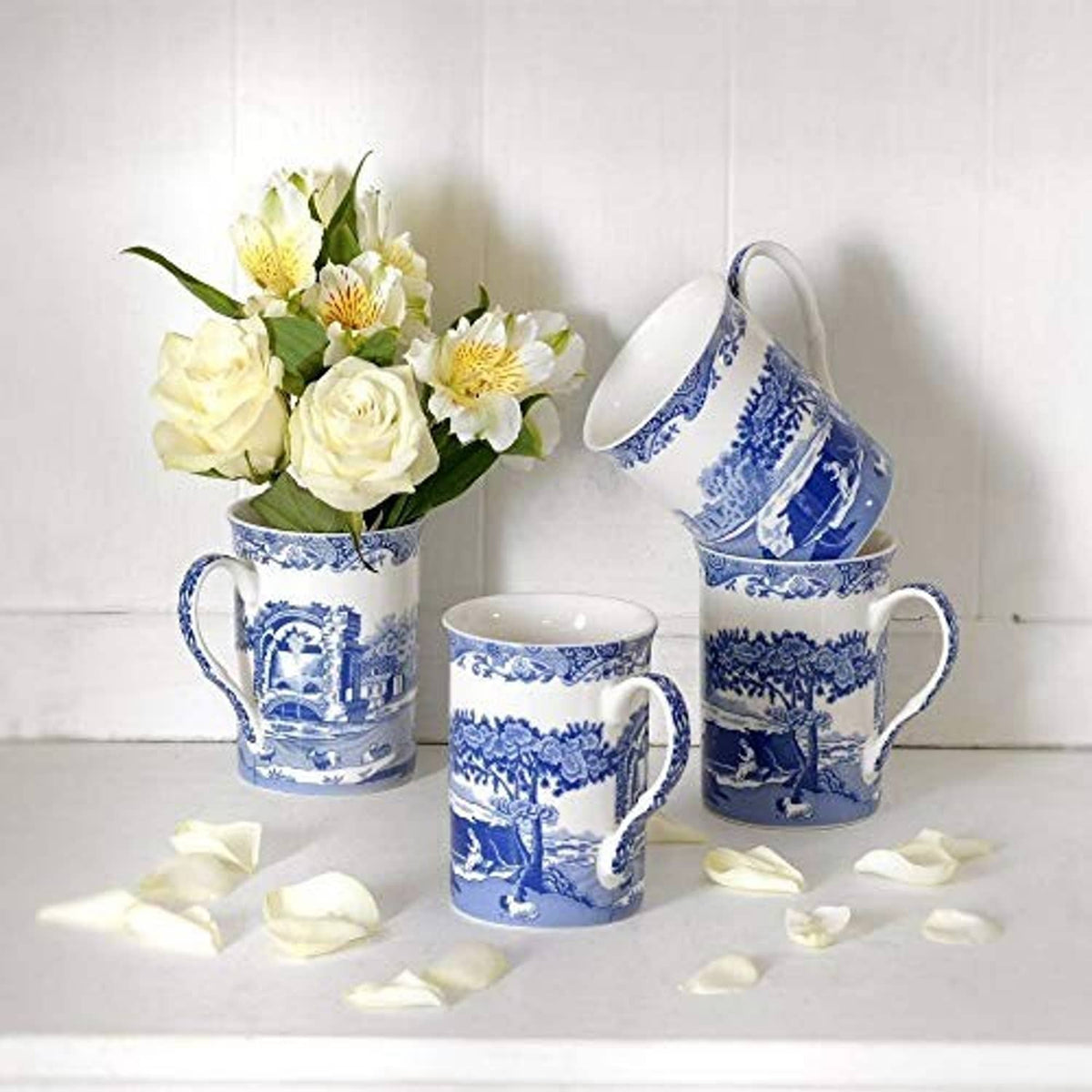 Blue and white ceramic mugs with landscape motif and curved handles