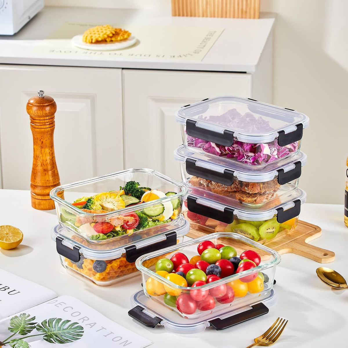 Set of clear glass meal prep containers with black latches, filled with colorful food