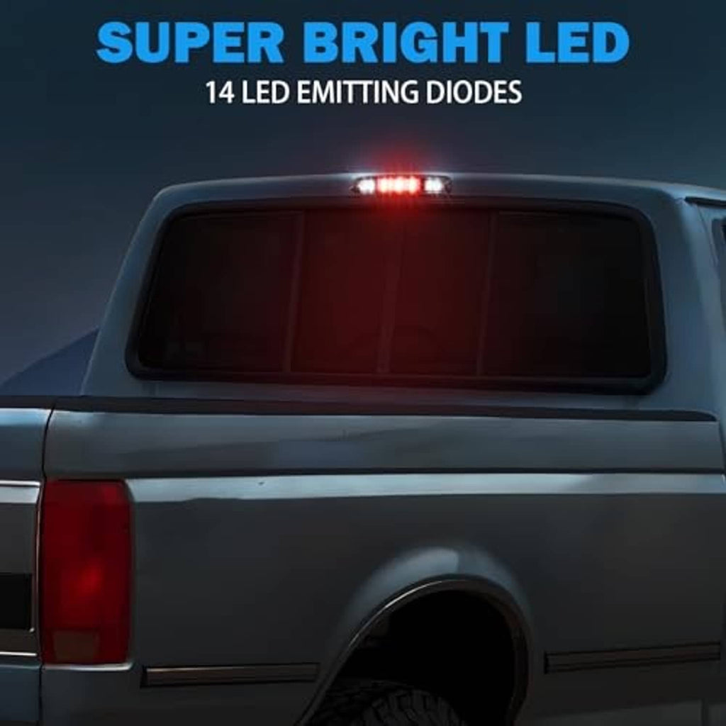 Third brake light on pickup rear, small red LED cluster glowing at the center.