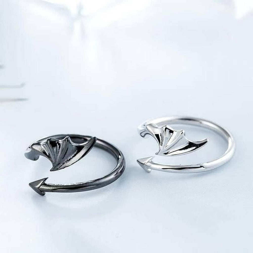 Two silver rings with bat-wing motifs on a light background