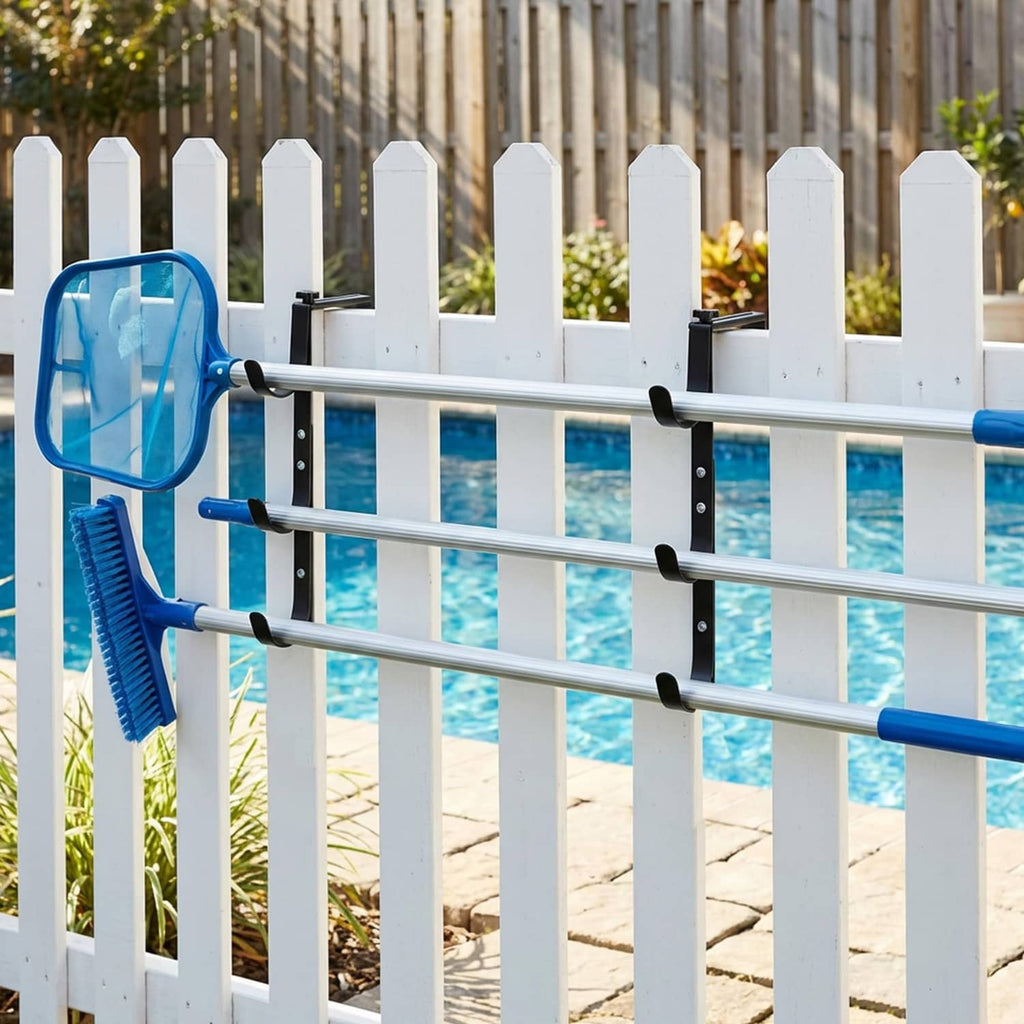 Black pool fence hooks mounted on rails holding pool brush and net