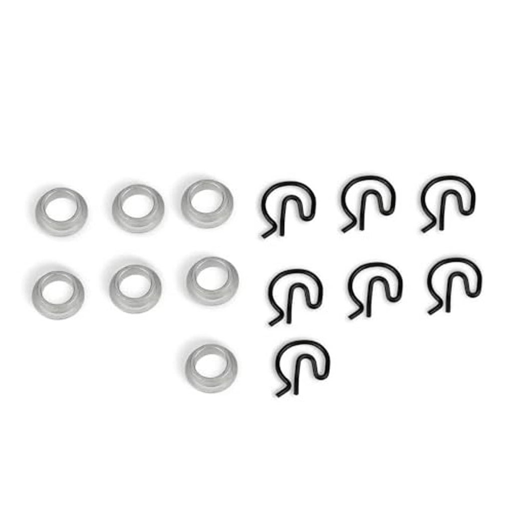 Manual shifter bushing kit showing steel sleeves and black spring clips, separated