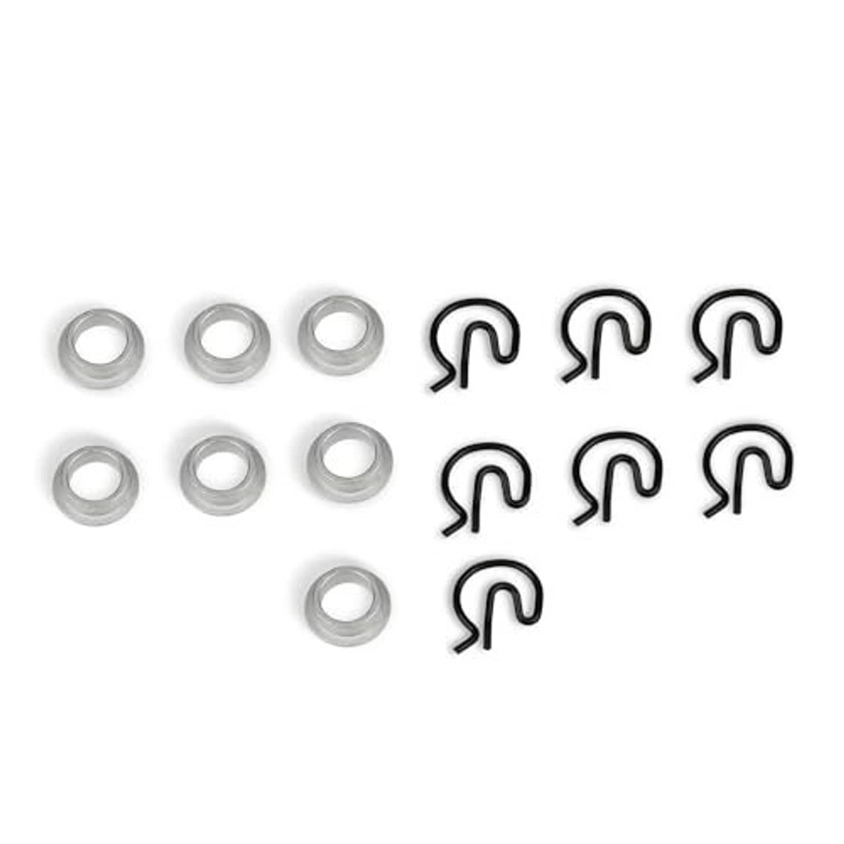 Manual shifter bushing kit showing steel sleeves and black spring clips, separated