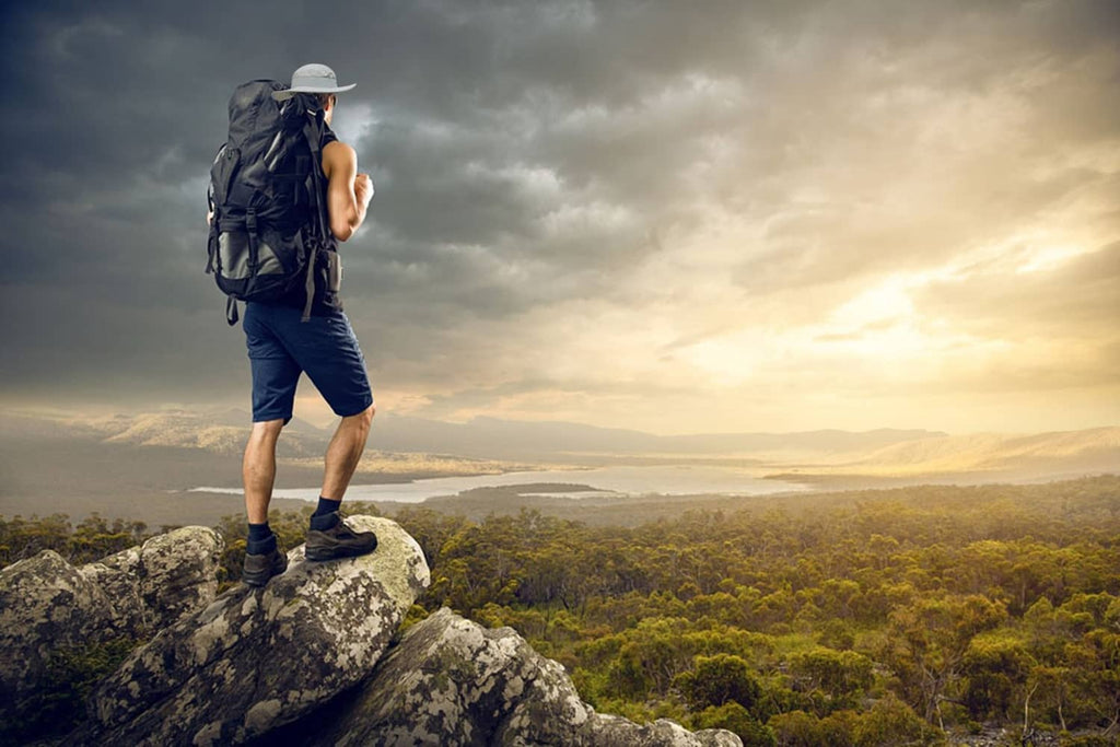 Wide-brim fishing cap worn by hiker, light gray with chin tie