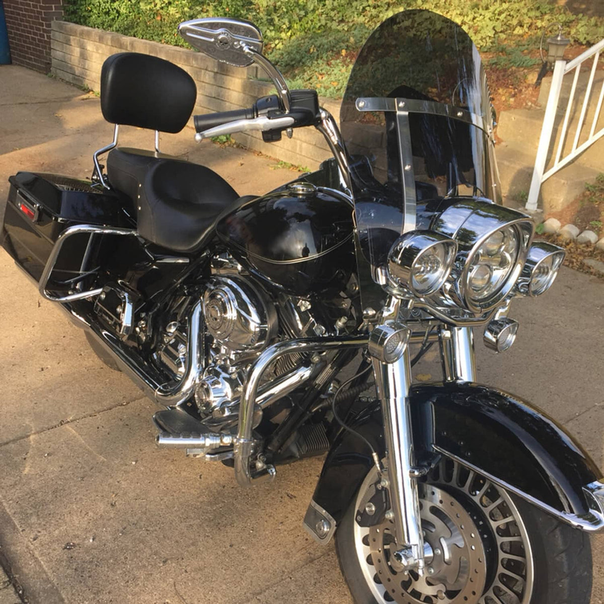 Detachable motorcycle windshield mounted on touring bike, clear smoke shield and chrome brackets
