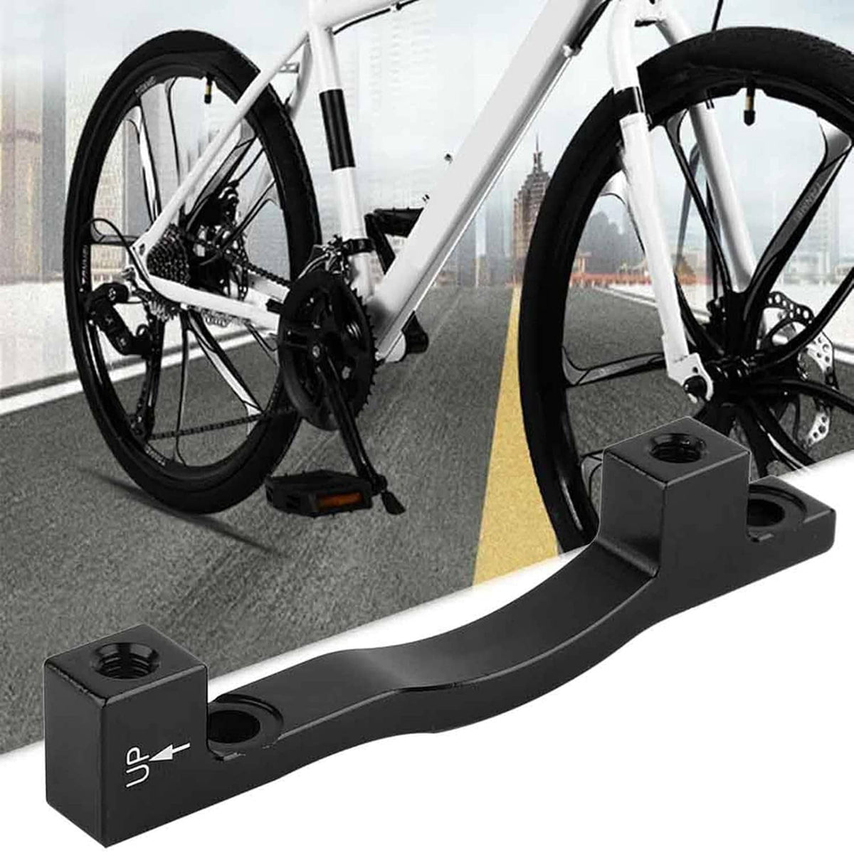 Black disc brake adapter bracket installed near front wheel on bicycle