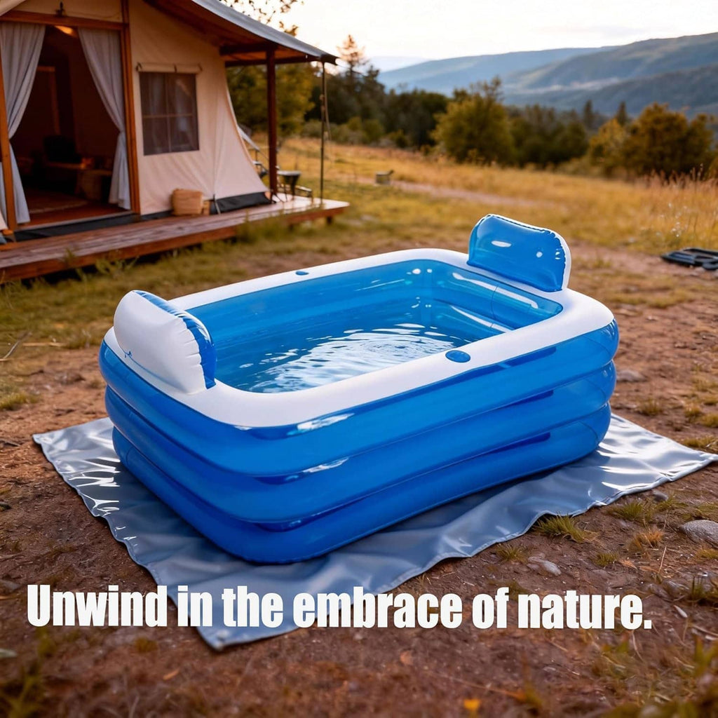Blue double inflatable bathtub with white rim and headrest set on an outdoor mat