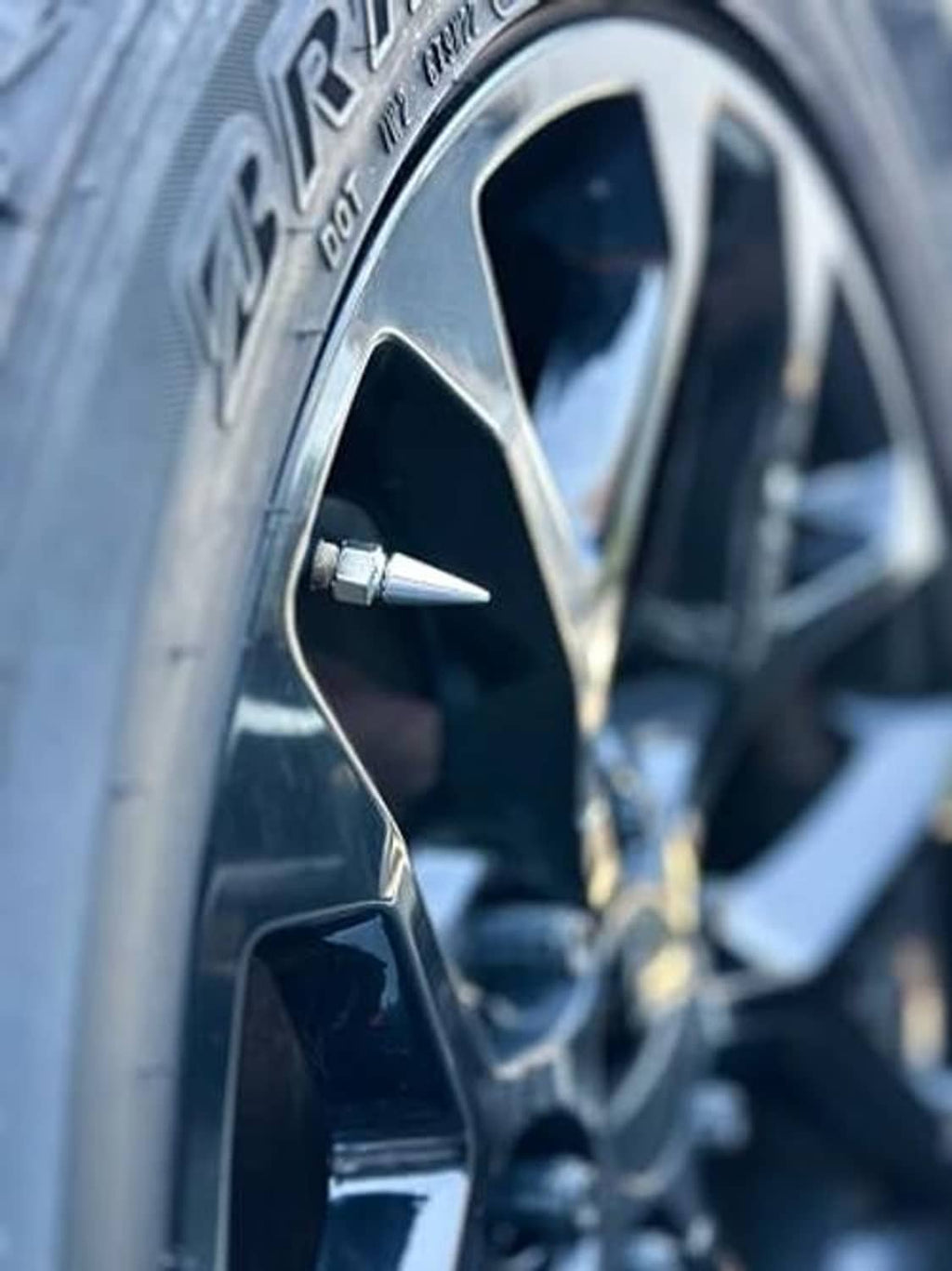 Chrome spike valve stem cap on tire wheel rim valve