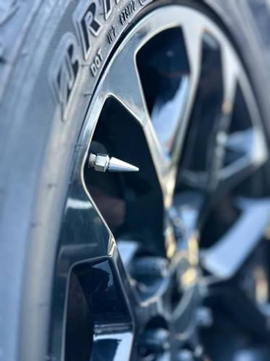 Chrome spike valve stem cap on tire wheel rim valve