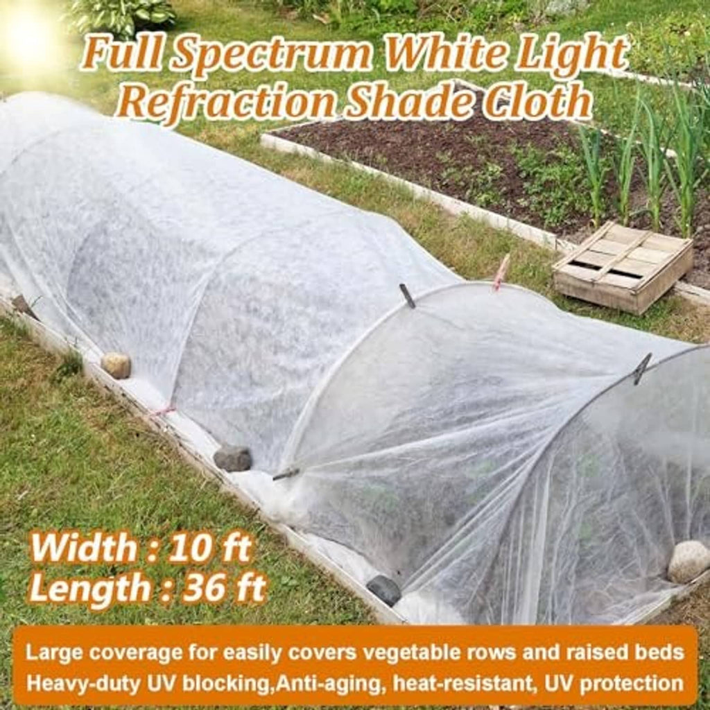 White shade cloth row cover, secured with stakes and tension ropes