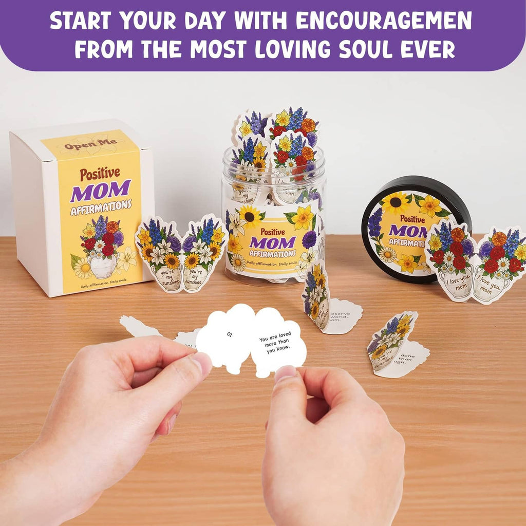 Mom affirmation jar with encouragement cards and gift box, hand holding a card