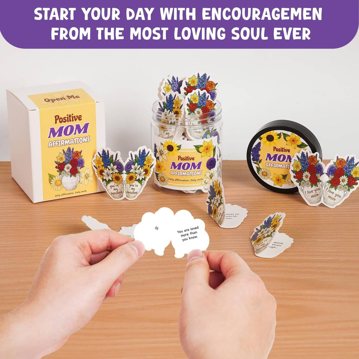 Mom affirmation jar with encouragement cards and gift box, hand holding a card