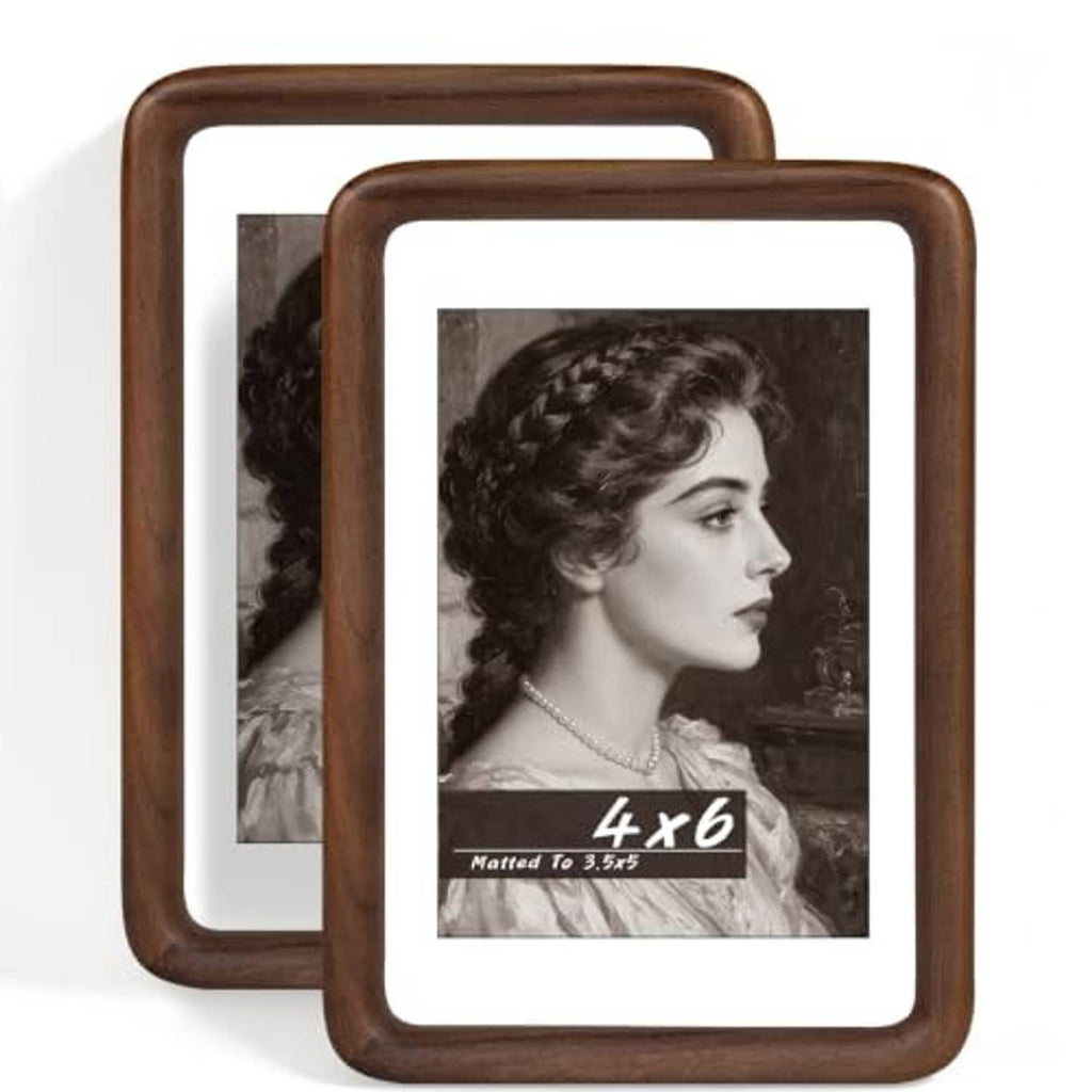 Set of two walnut wood photo frames with white mat, featuring black-and-white portrait photos