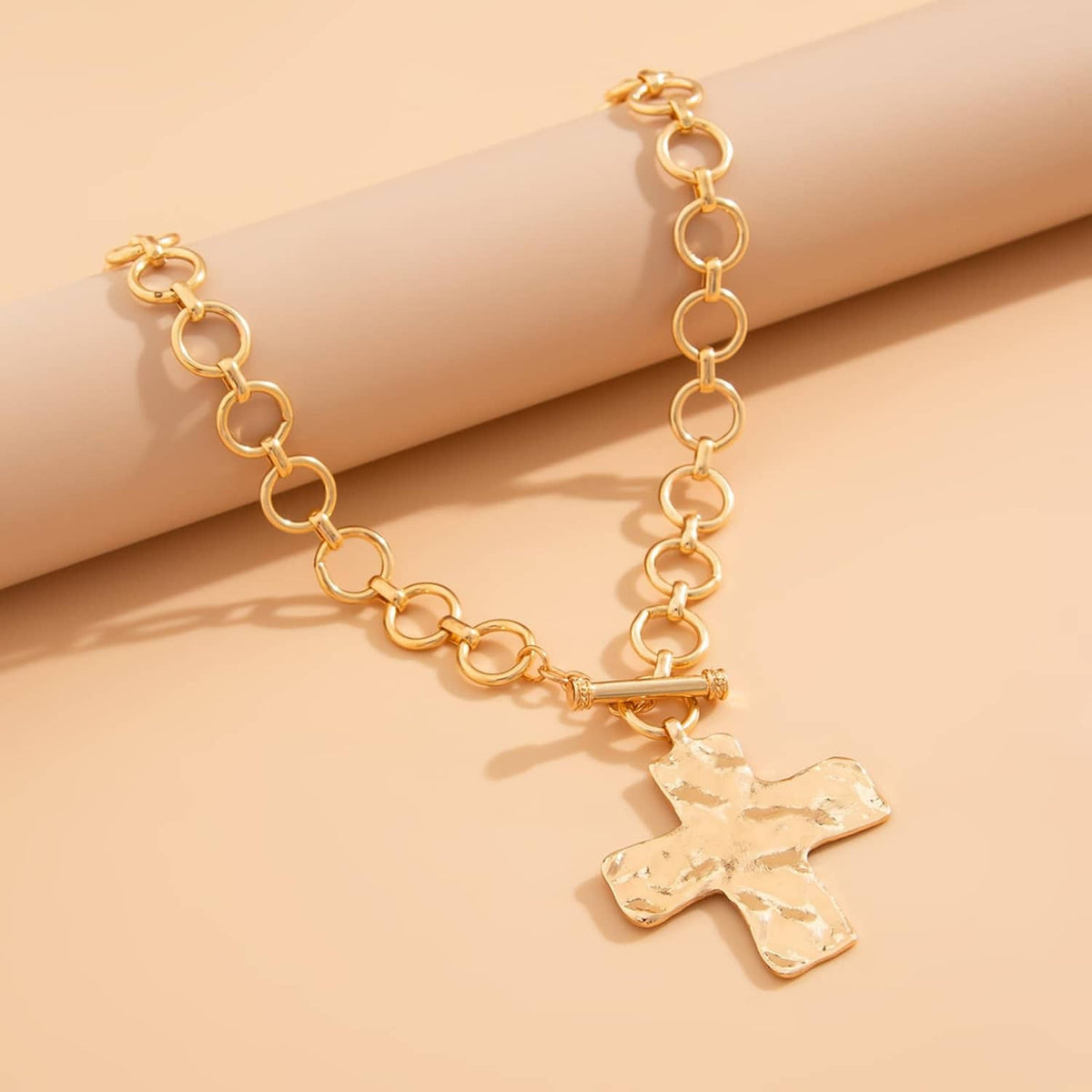 Gold-tone chunky chain necklace with textured cross pendant and extender