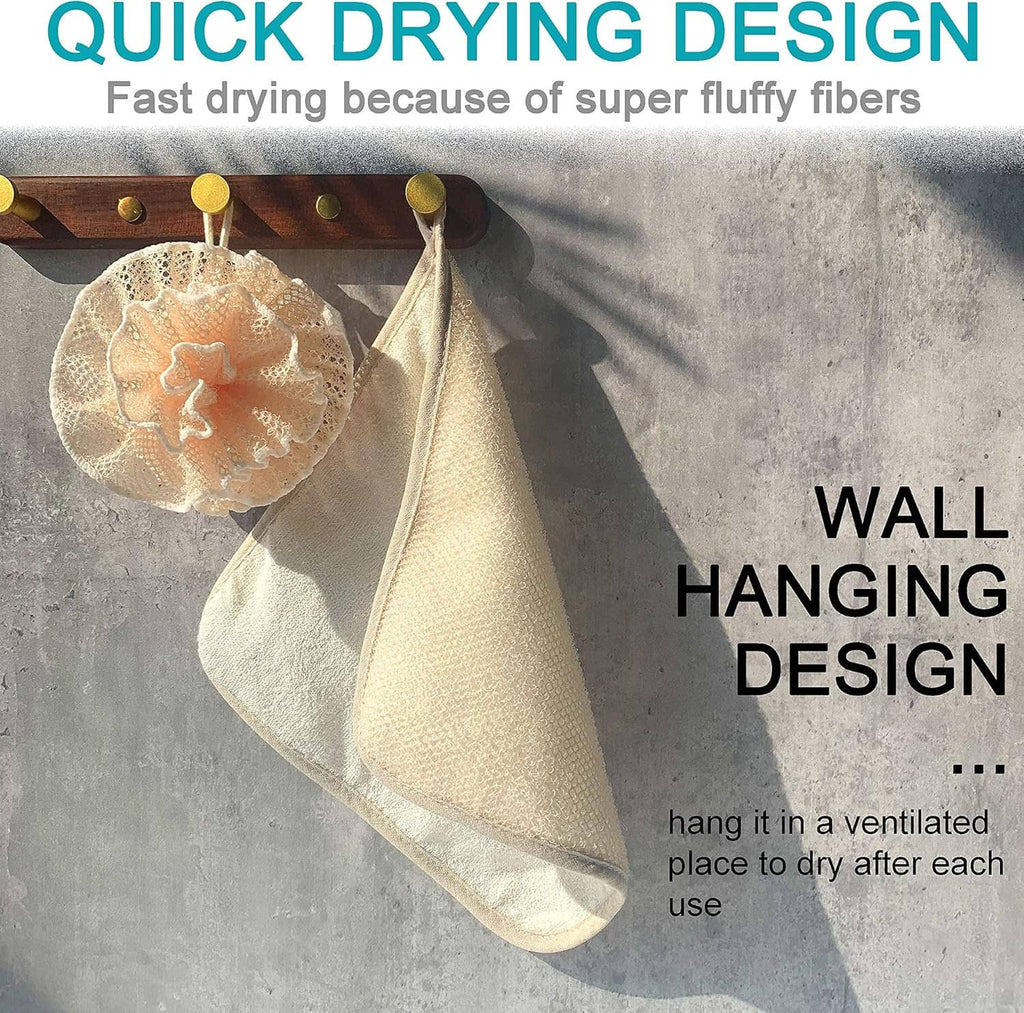 Ivory mesh shower pouf loofah hangs on wall hook for drying, with textured scrubbing face