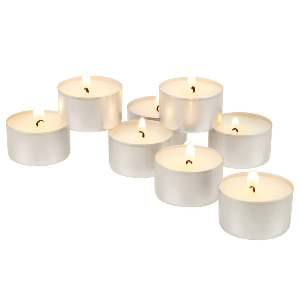 White unscented tea light candles with flames, arranged in a group