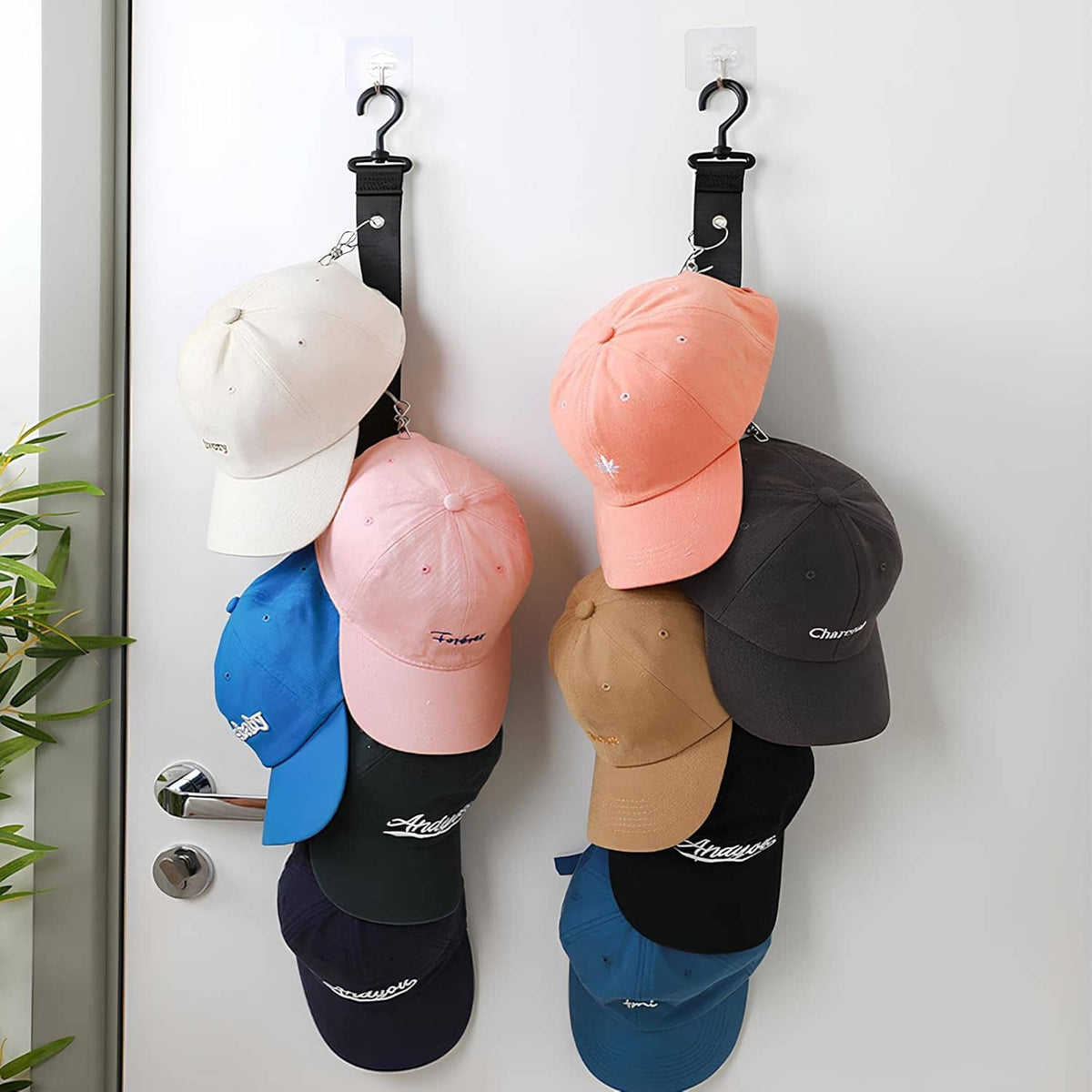 Door hat rack holding white, pink, blue, tan, and black baseball caps
