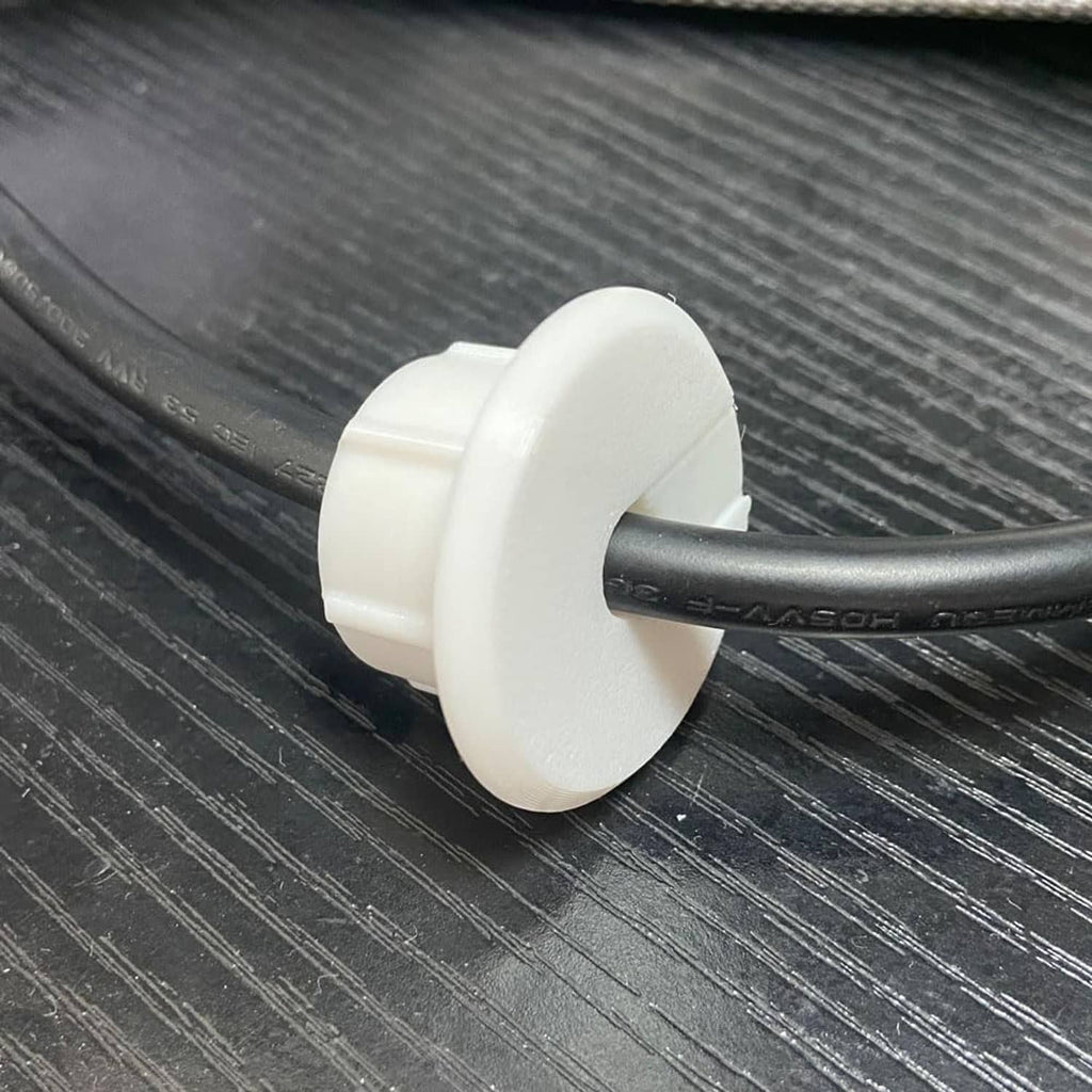 White grommet base mounted on black cable, secure snap fit