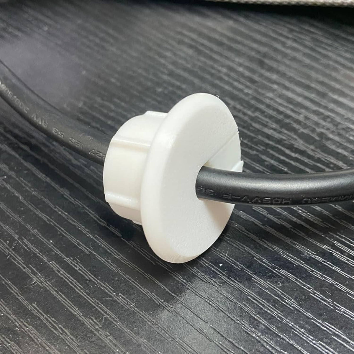 White grommet base mounted on black cable, secure snap fit