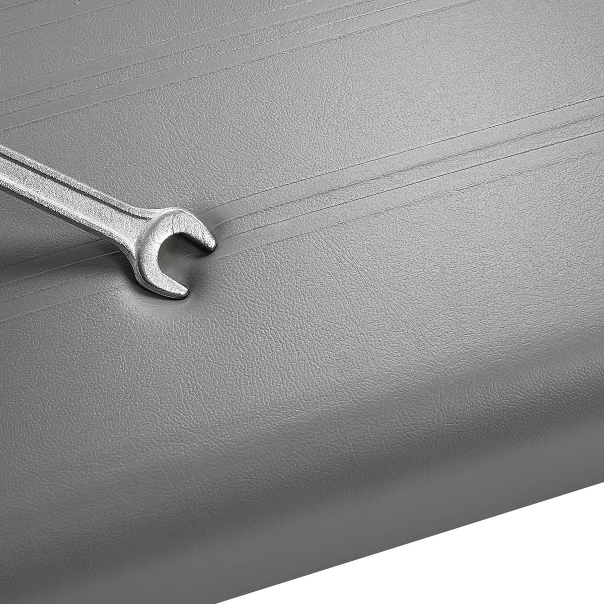 Gray cushion seam with wrench head shown near hardware area