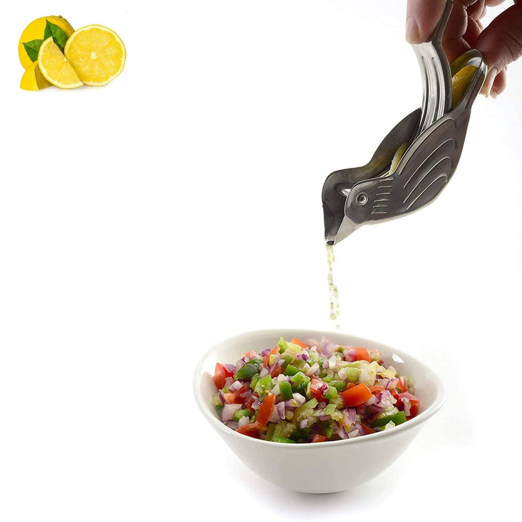 Stainless bird-shaped citrus juicer squeezing juice into a bowl of chopped salad