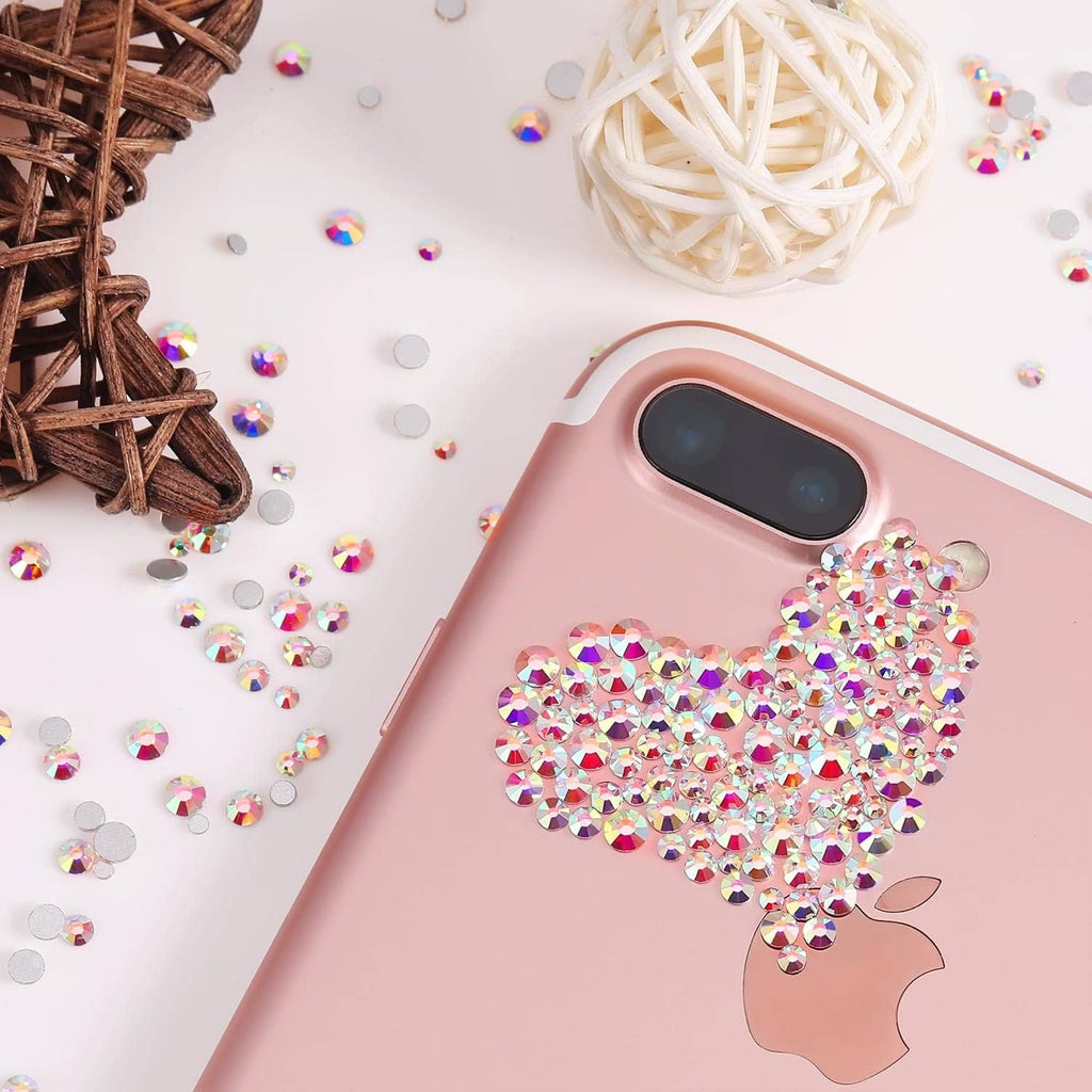 Pink phone case decorated with a rhinestone bow and scattered crystal accents.
