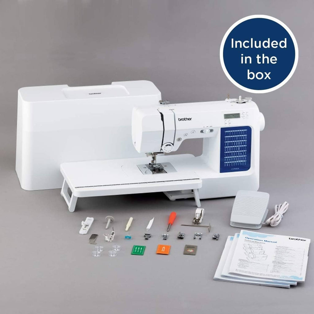 White sewing machine with included accessories and instruction materials