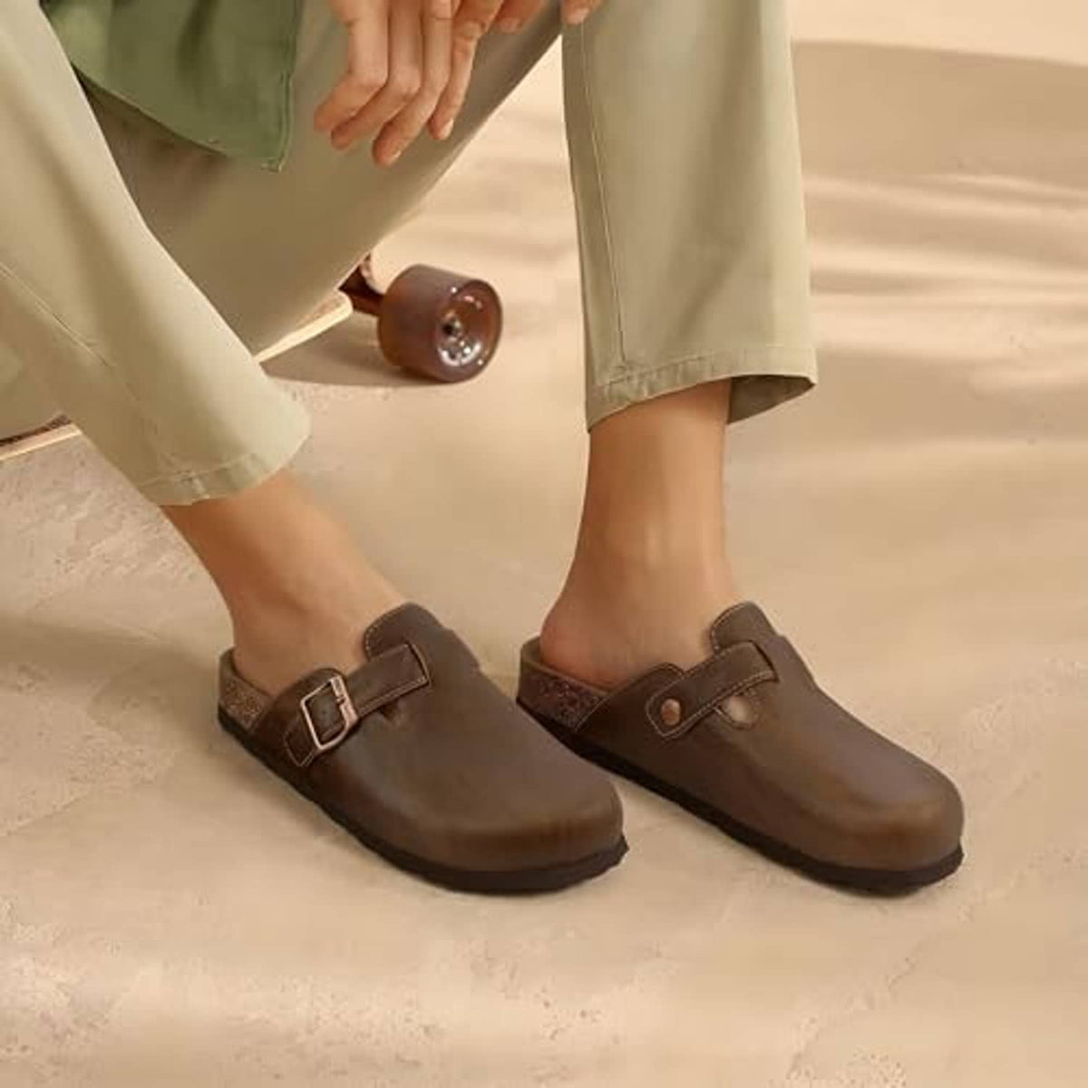 Mocha unisex clogs with adjustable buckle strap and cork sole worn with pants