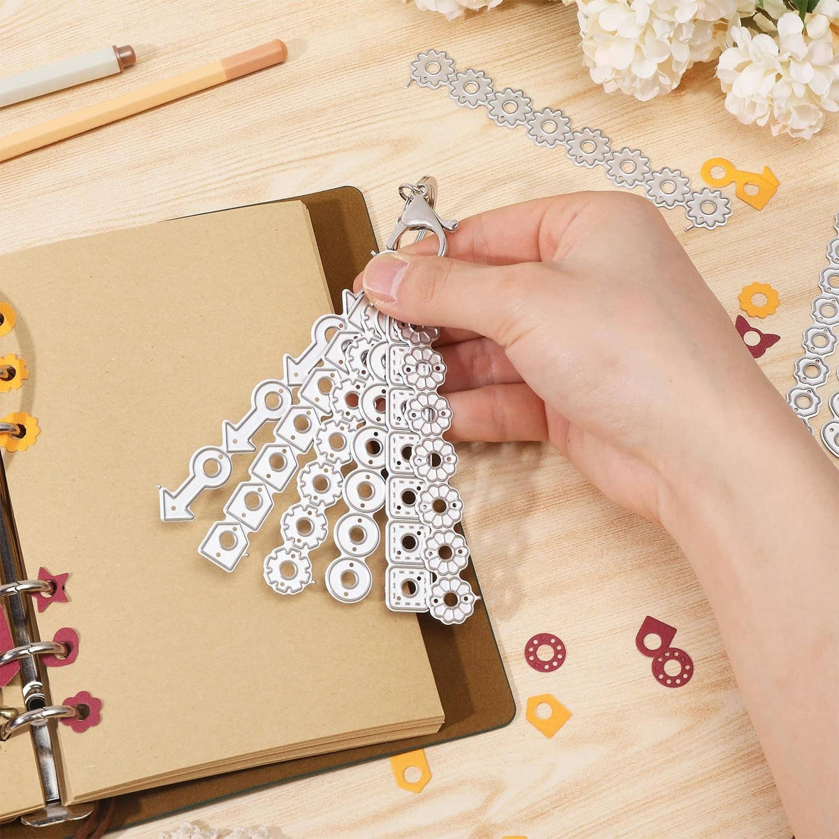 Hand applying page tab hole reinforcement die cut shapes onto scrapbook paper