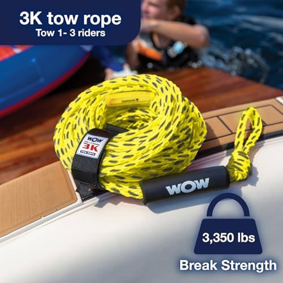 Coiled neon yellow tow rope with black foam handle beside a dock