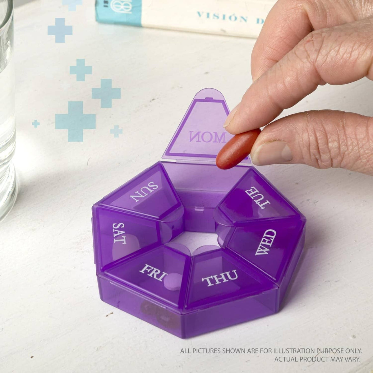 Purple weekly pill organizer with clear day-labeled compartments; hand placing a pill