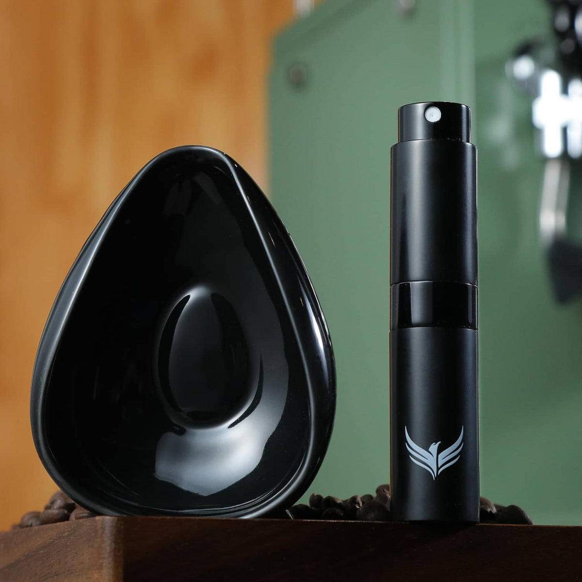 Black coffee dosing cup and black RDT sprayer standing on a countertop