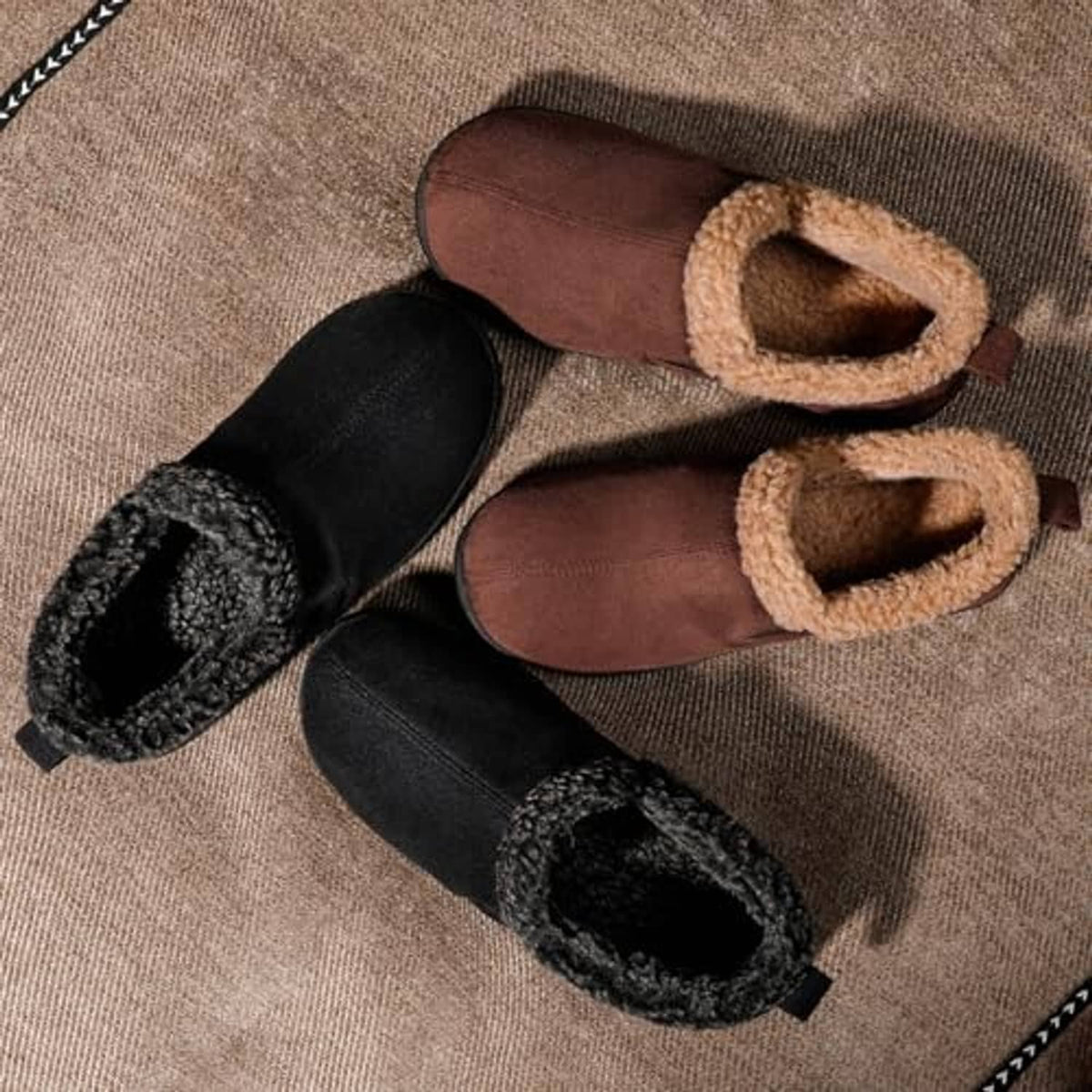 Black suede bootie slippers with plush sherpa lining and moc-toe style trim.