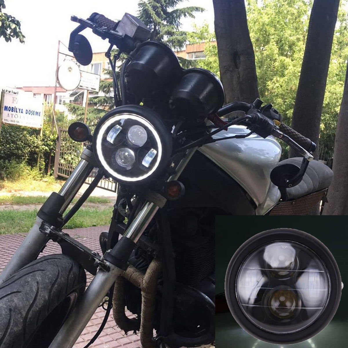 Round black LED motorcycle headlight mounted on a handlebar with wiring visible
