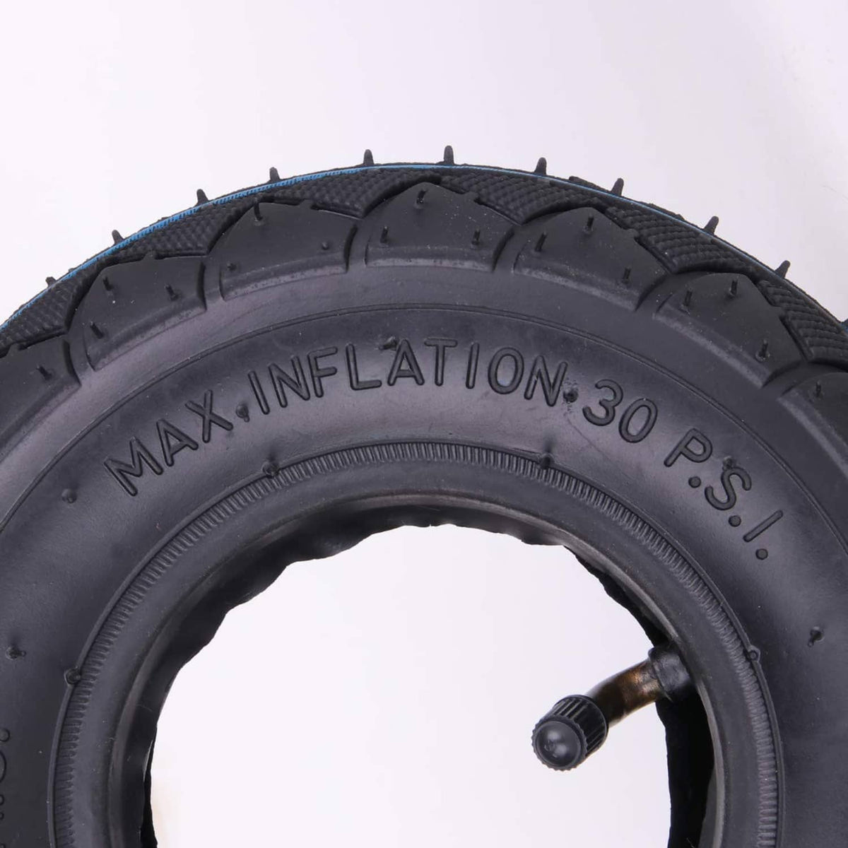 Black tire sidewall close-up with max inflation 30 PSI marking and valve stem