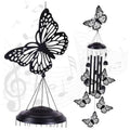 Black butterfly wind chime with five hanging bars and metal butterfly cutouts