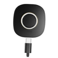 Black charging dock base with circular gold ring and connected USB-C cable
