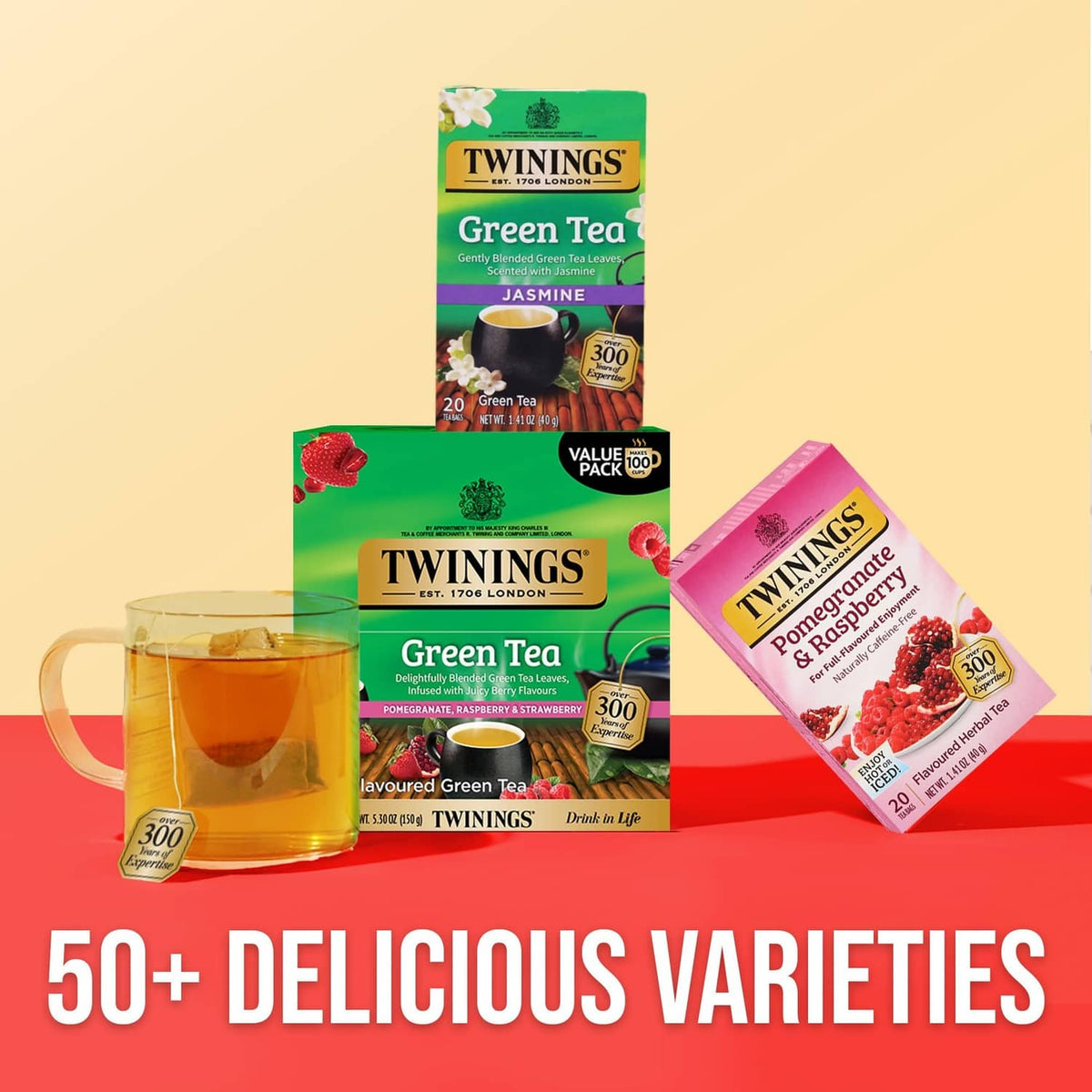 Assorted Twinings green tea boxes with brewed tea glass and teacup